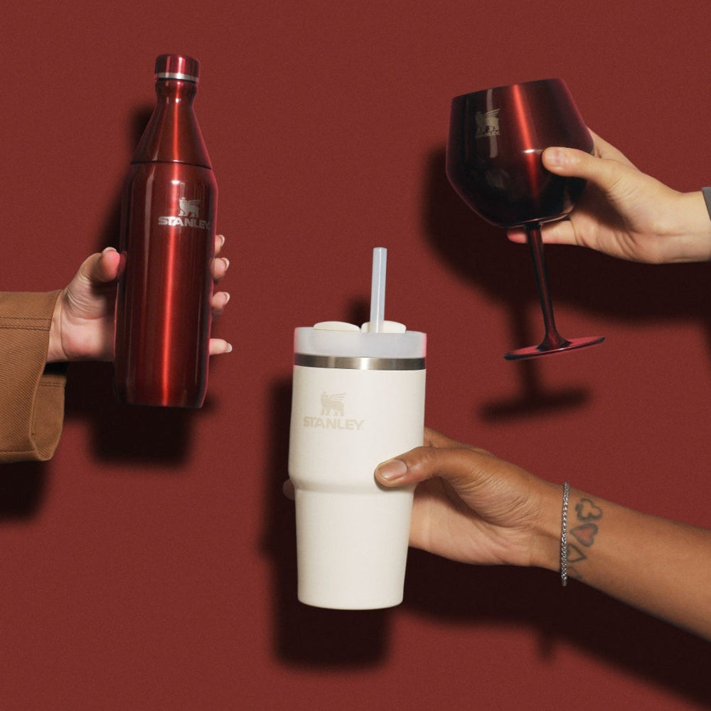Three people holding a red bottle and a white tumbler with a straw on a red background