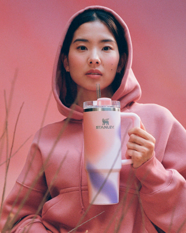 Front shot camera of a woman holding the New Frequency Quencher